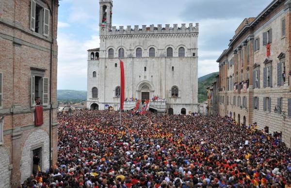 Palazzo dei Consoli and Piazza Grande crowded with people during Festa dei Ceri